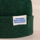 Forest green cropped above-ear beanie with woven DMD label