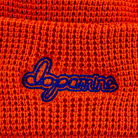 Orange Script Beanie with embroidered “dopamine” text – close up