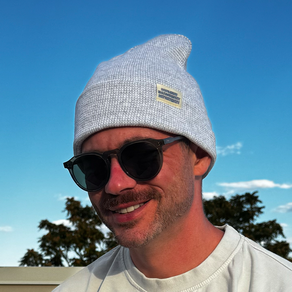 Model wearing Heather Beanie in grey & white with sunglasses