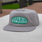 Gray cap with green and white text on a blurred background