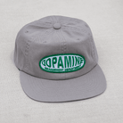 Gray cap with a green and white logo on a light gray background