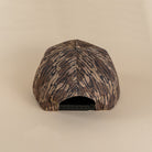 Back view woodland camo snapback with adjustable closure
